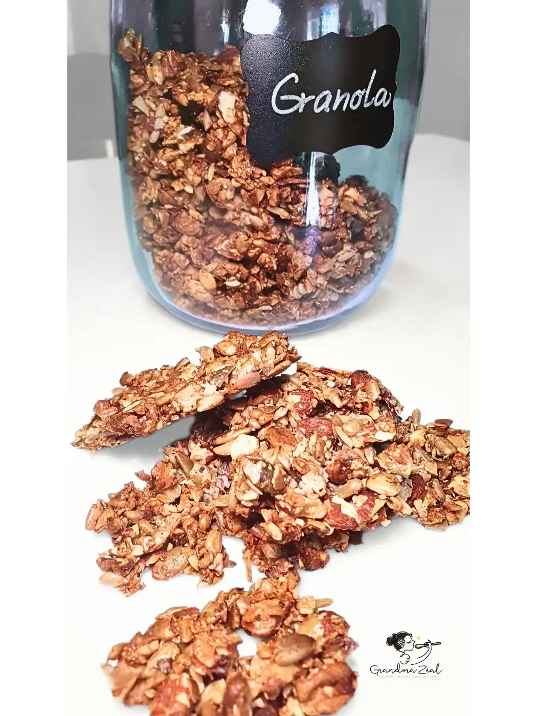 Low-carb granola with nuts in a glass jar, some scattered on the table