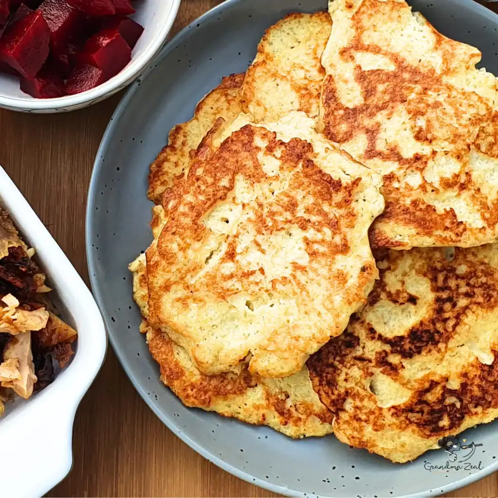 eleriac fritters served with shredded meat and pickled beetroot on a plate