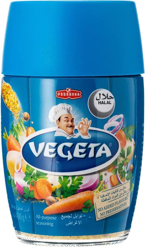 Original Vegeta seasoning package by Podravka, standing on a kitchen counter.