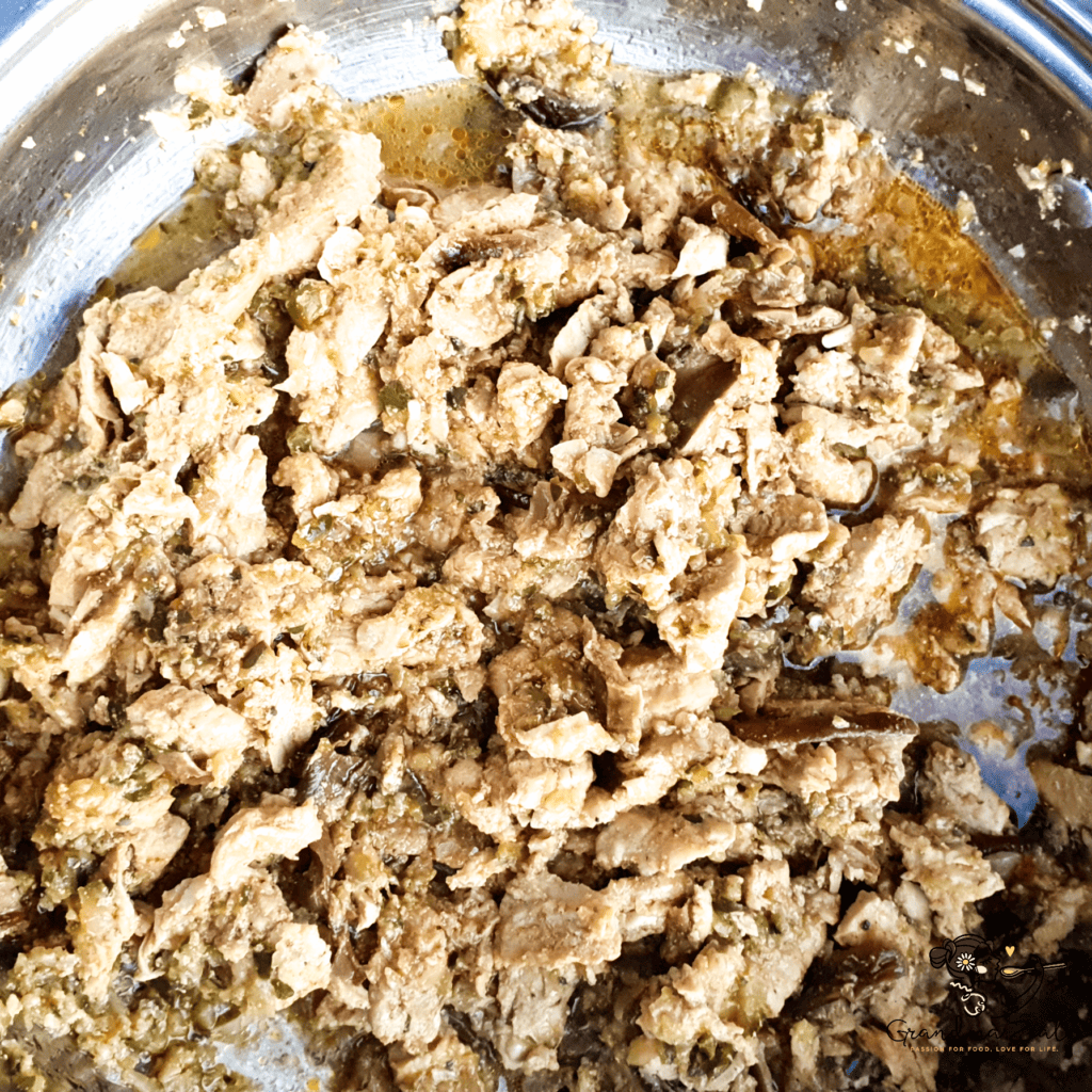 Chicken stroganoff nearly cooked in a skillet, with chicken, vegetables, and spices well combined and simmering.