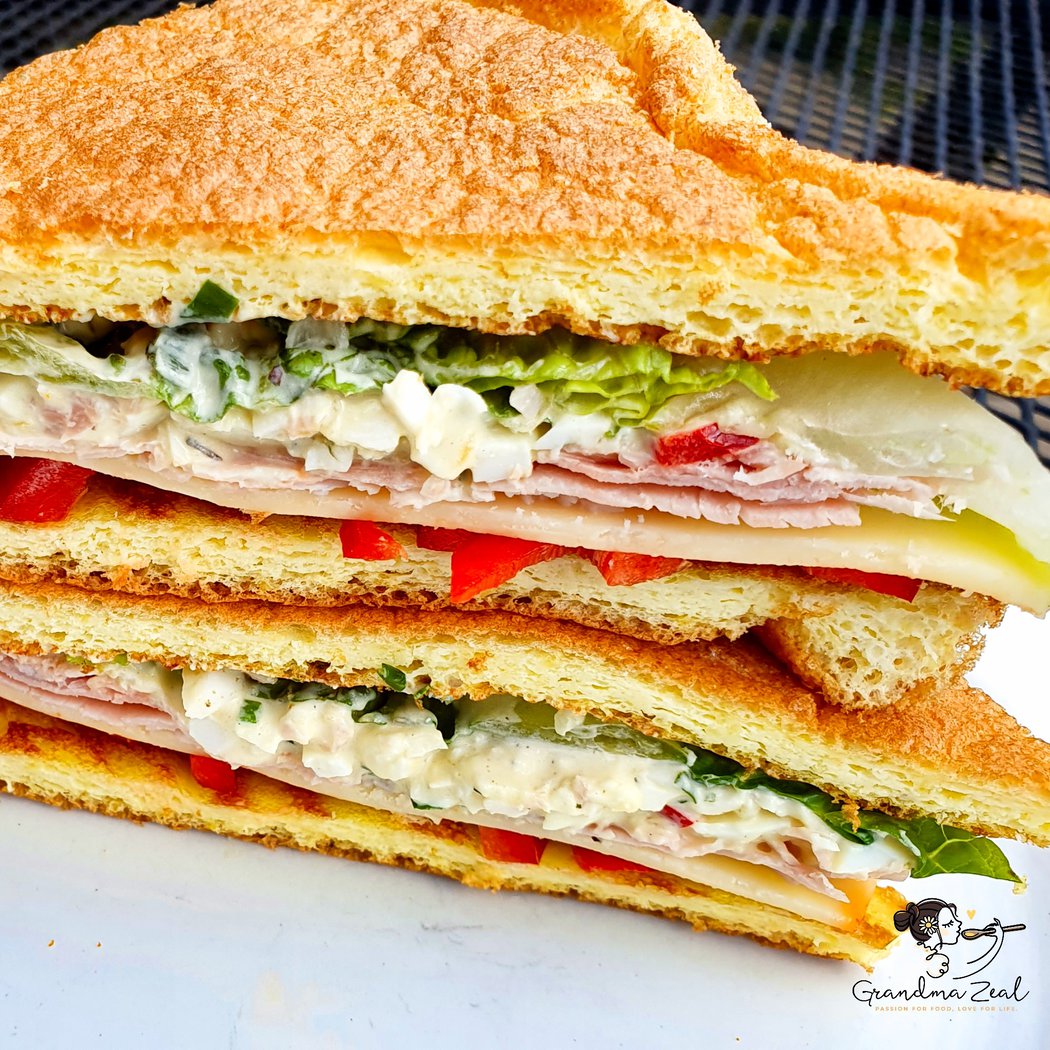 a keto cloud bread  sandwich cut in half