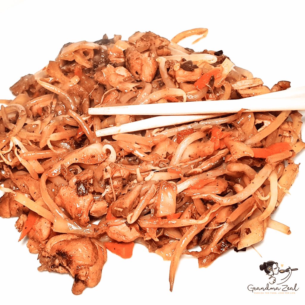 Easy chicken chow mein served on a plate with chopsticks placed on top