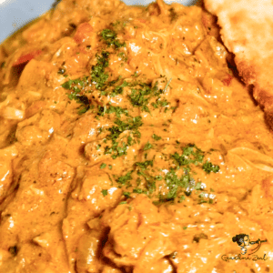 Close-up of chicken-aubergine curry with creamy sauce -featured picture