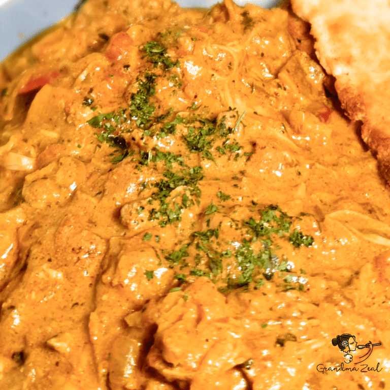 CHICKEN-AUBERGINE CURRY RECIPE – FLAVOURFUL & HEALTHY Close-up of chicken-aubergine curry with creamy sauce -featured picture