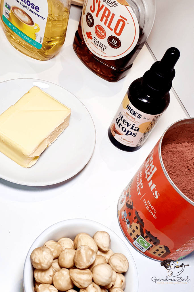 Ingredients for sugar-free chocolate including cacao butter, cocoa powder, Sukrin syrup, vanilla stevia, and hazelnuts
