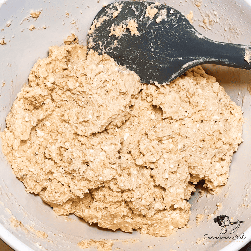Keto rye bread dough fully mixed and resting in a bowl, ready to sit for 15 minutes before baking.