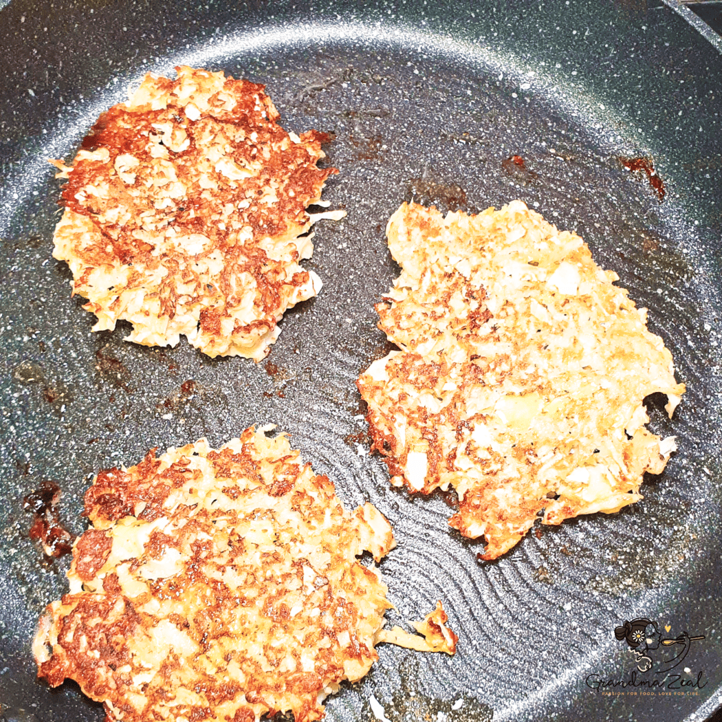 Veggie hash browns frying in a skillet until golden and crispy