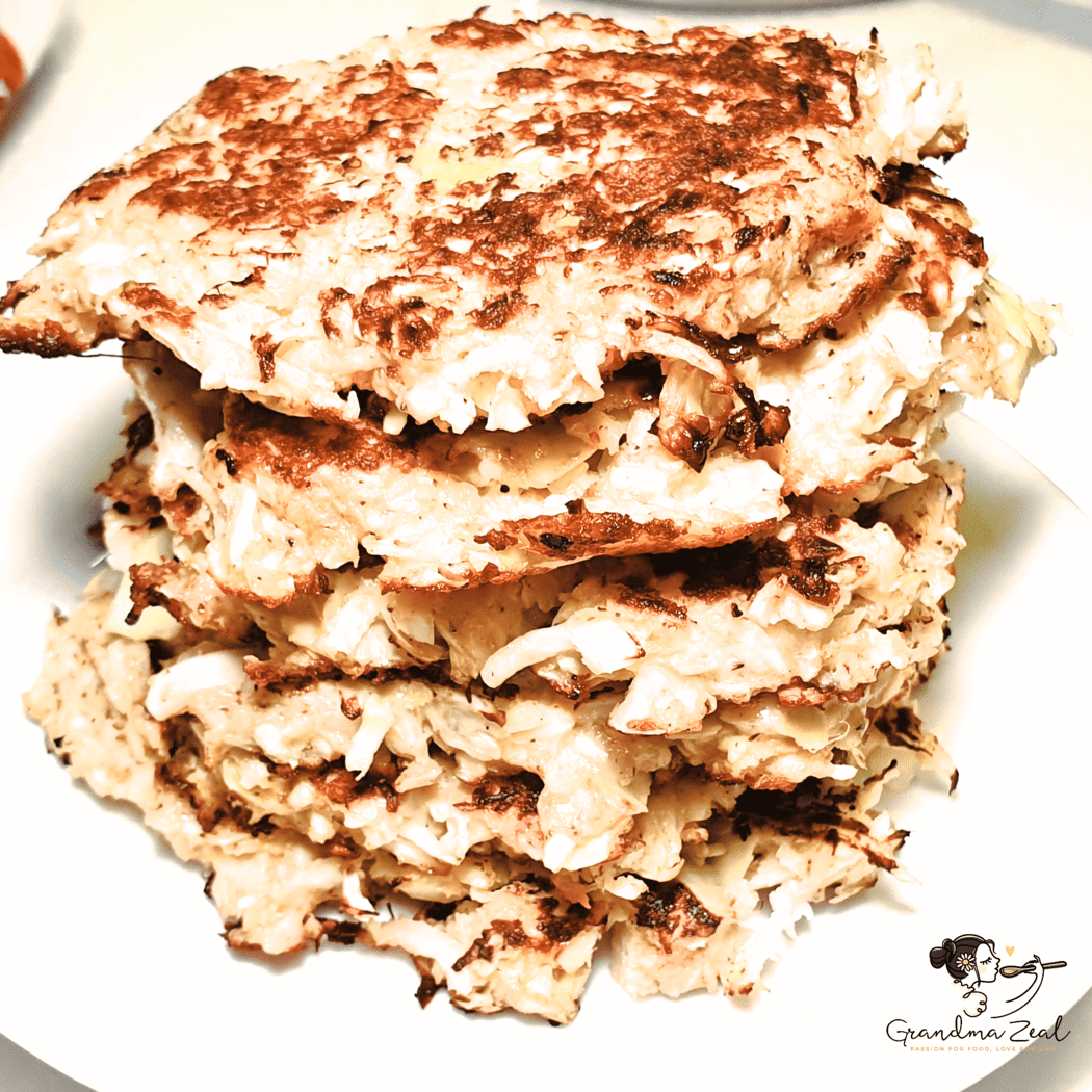 Stack of golden-brown veggie hash browns with cheese, served on a plate