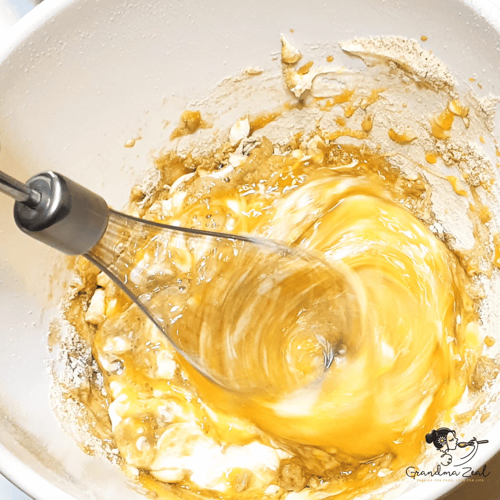 Blending egg, fibre, and cream cheese in a bowl to prepare the batter for high-fibre low-carb pasta.