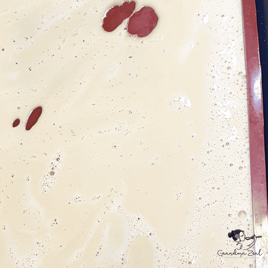 Even layer of high-fibre pasta batter spread on a flat silicone baking form, ready to bake.