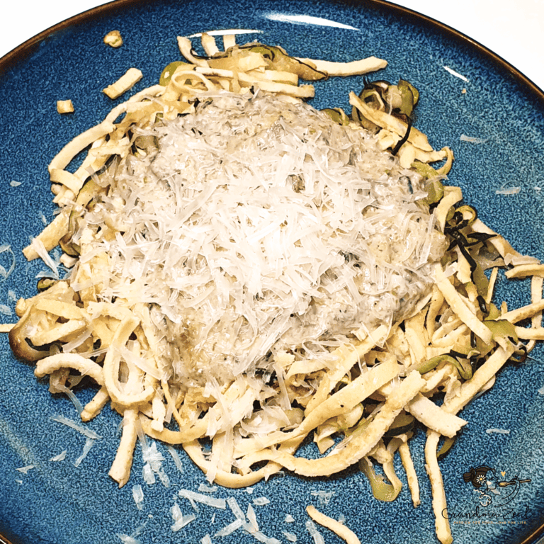 HEALTHY PASTA CARBONARA WITH HIGH-FIBRE NOODLES & ZOODLES A serving of healthy pasta carbonara with zoodles and high-fibre noodles, topped with grated parmesan and black pepper.