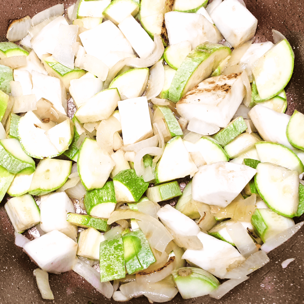 Chopped green vegetable in the pot ready to cook