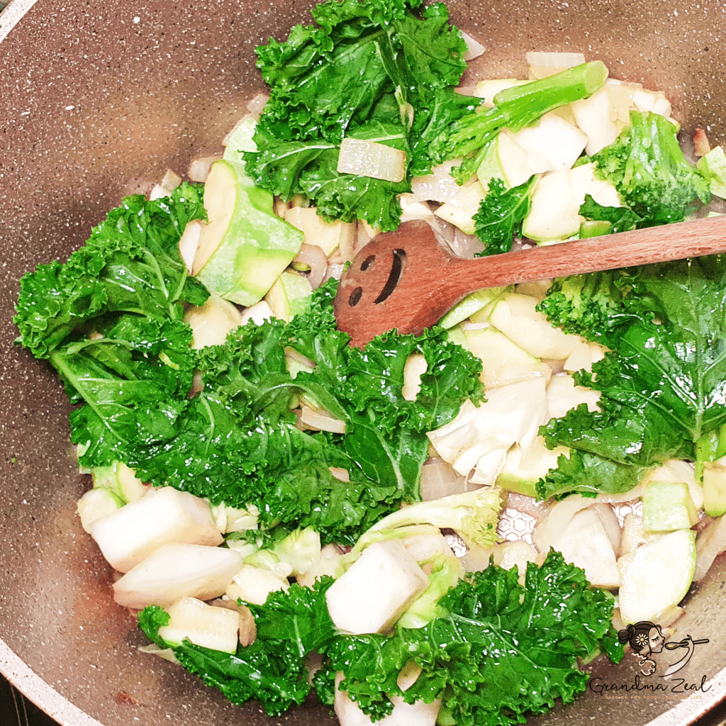  Leafy green vegetables being added to the pot for healthy green vegetable soup with cheese