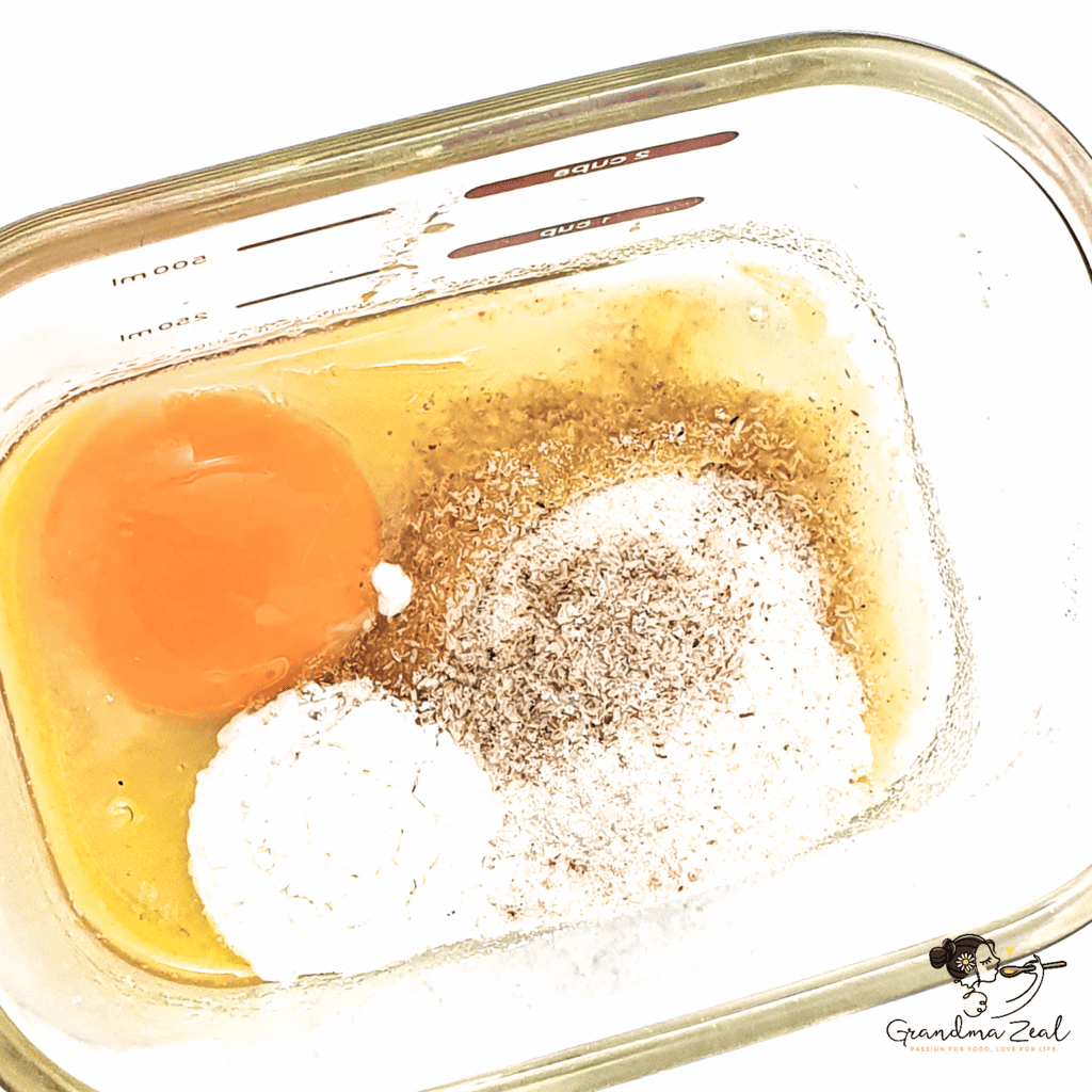 Close-up of all ingredients for 90-second microwave bread mixed in a rectangular glass dish