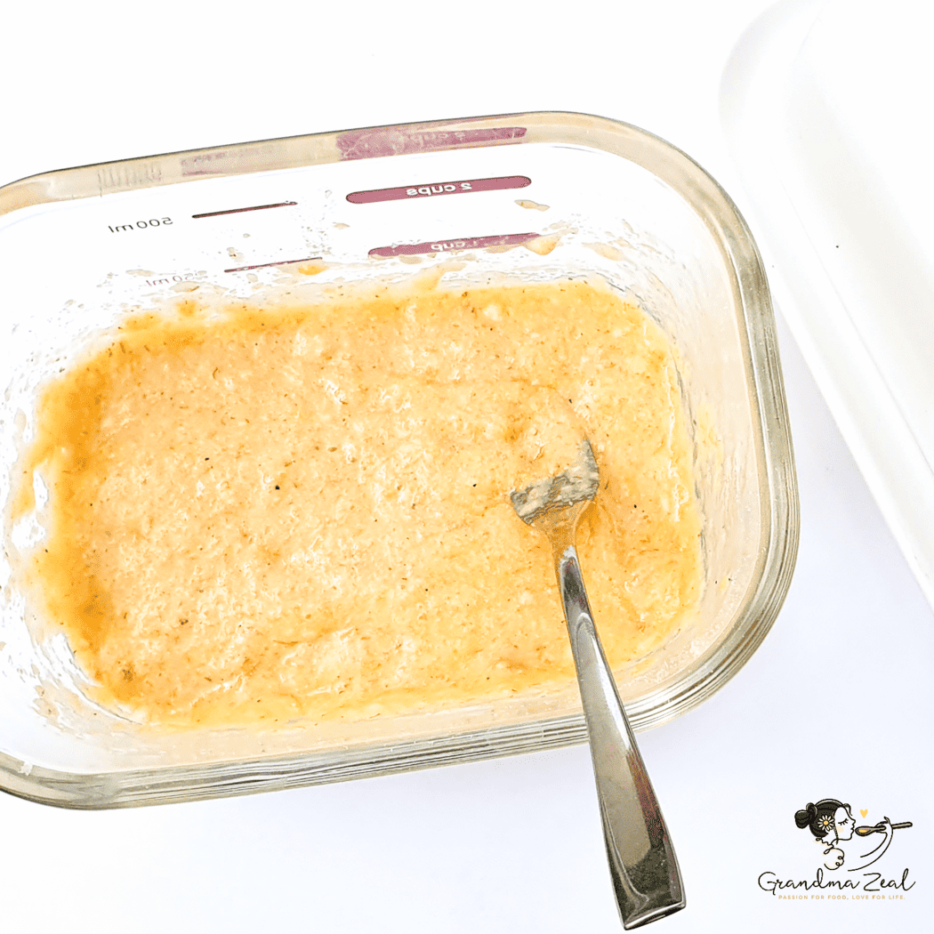 Close-up of fully mixed ingredients for 90-second microwave bread in a rectangular glass dish