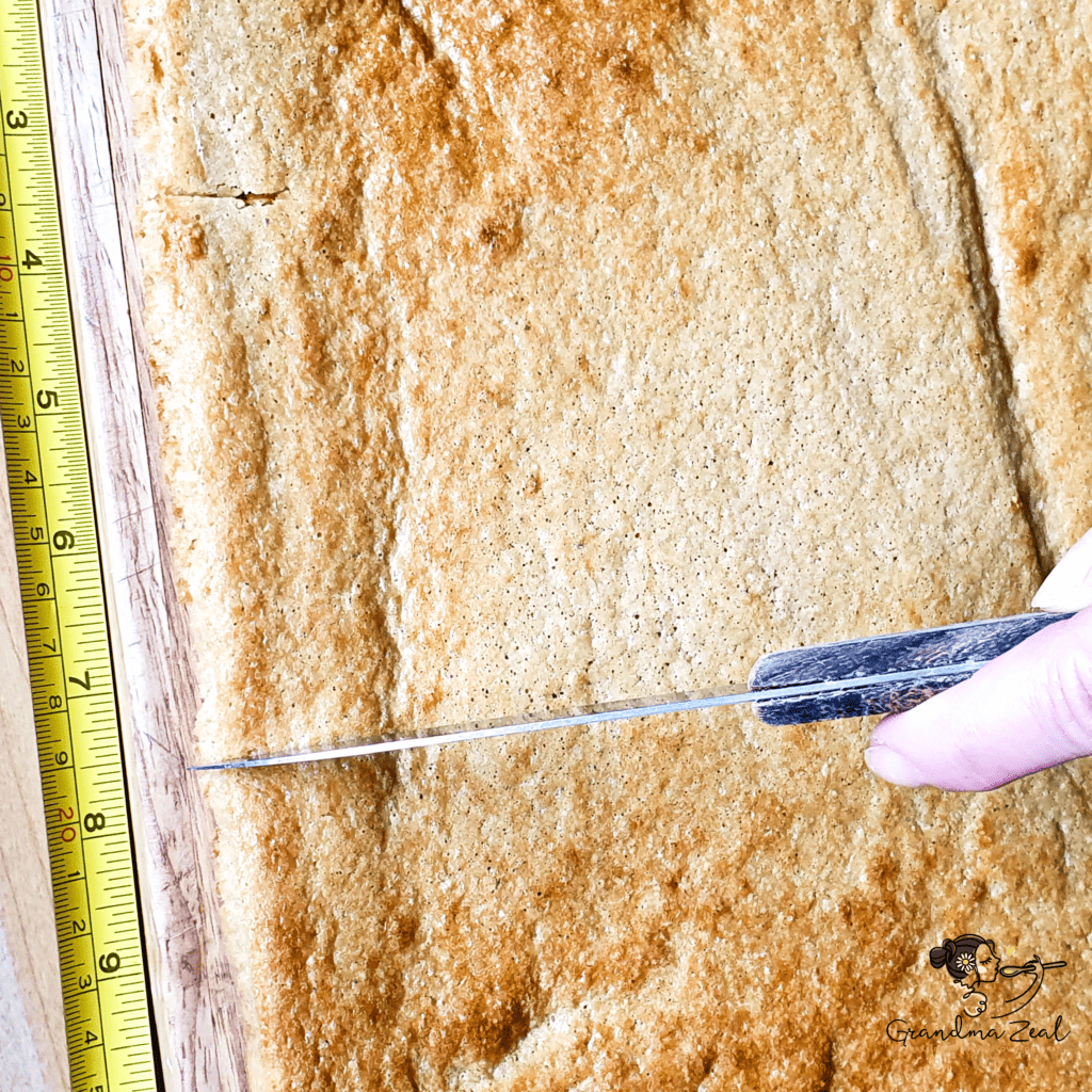 Cutting low-carb honey cake into layers using a tape measure for even slices