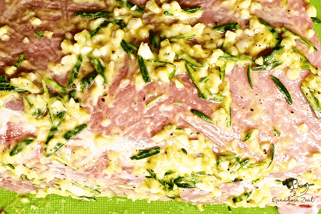 Pork loin coated in rosemary and garlic marinade, ready to be seared