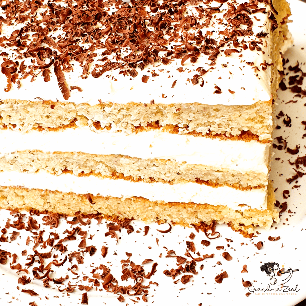 Close-up view of low-carb honey cake topped with chocolate shavings