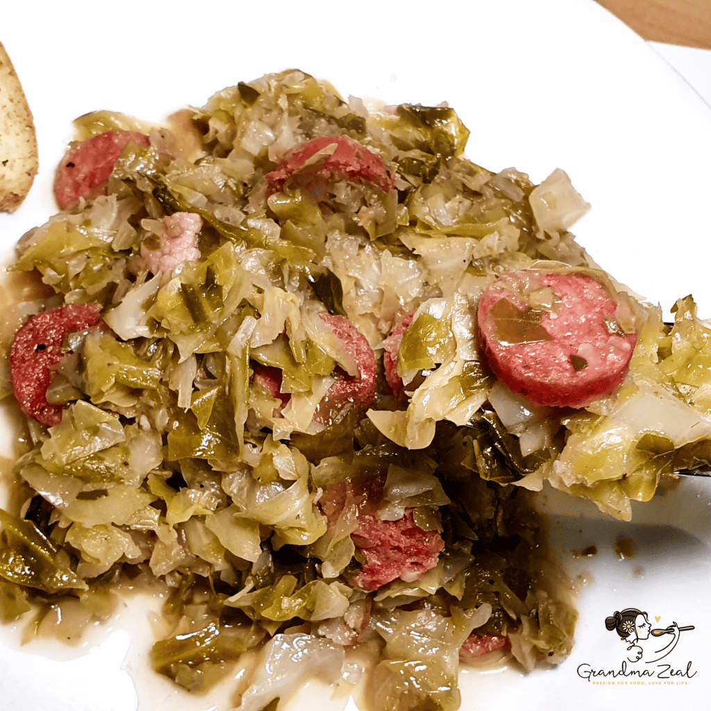 Cooked sweet cabbage served with German-style sausage on a plate.