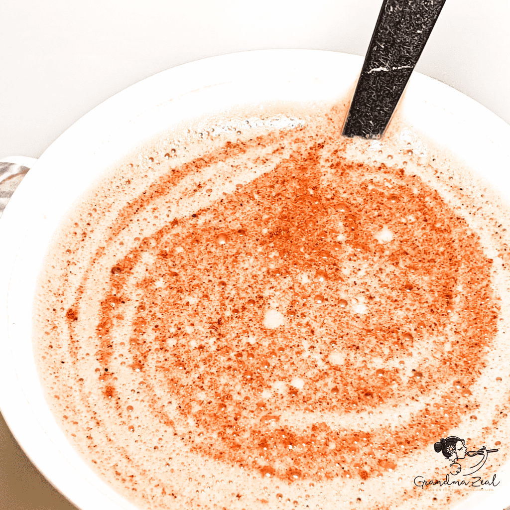 Close-up of high-protein hot chocolate with a spoon in the mug