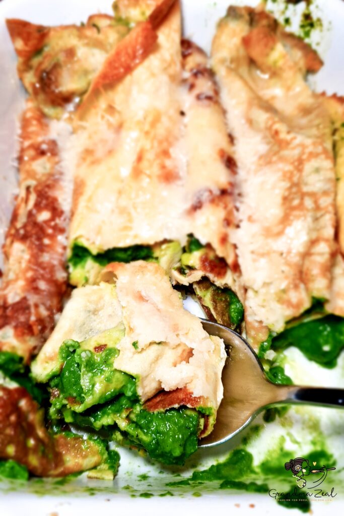 Classic crepes filled with spinach and topped with parmesan