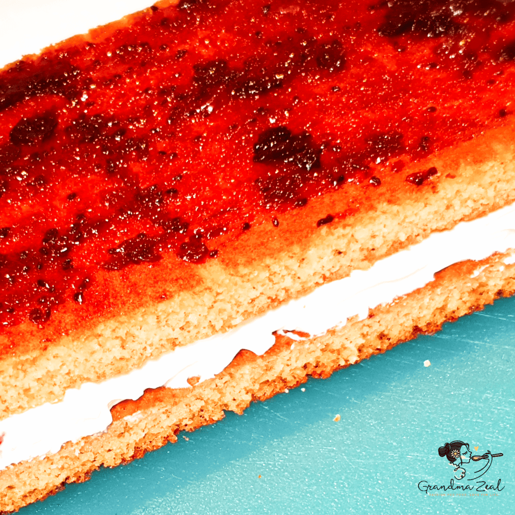 Close-up view of spread jam on the middle layer of low-carb honey cake
