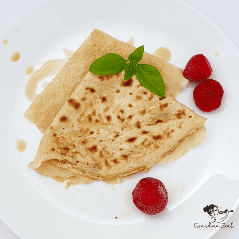 Classic crepes folded into triangles and topped with fresh raspberries; featured image for a sweet crepe recipe