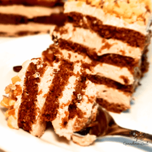 A portion of low-carb coffee walnut cake with a piece on the fork, ready to eat.