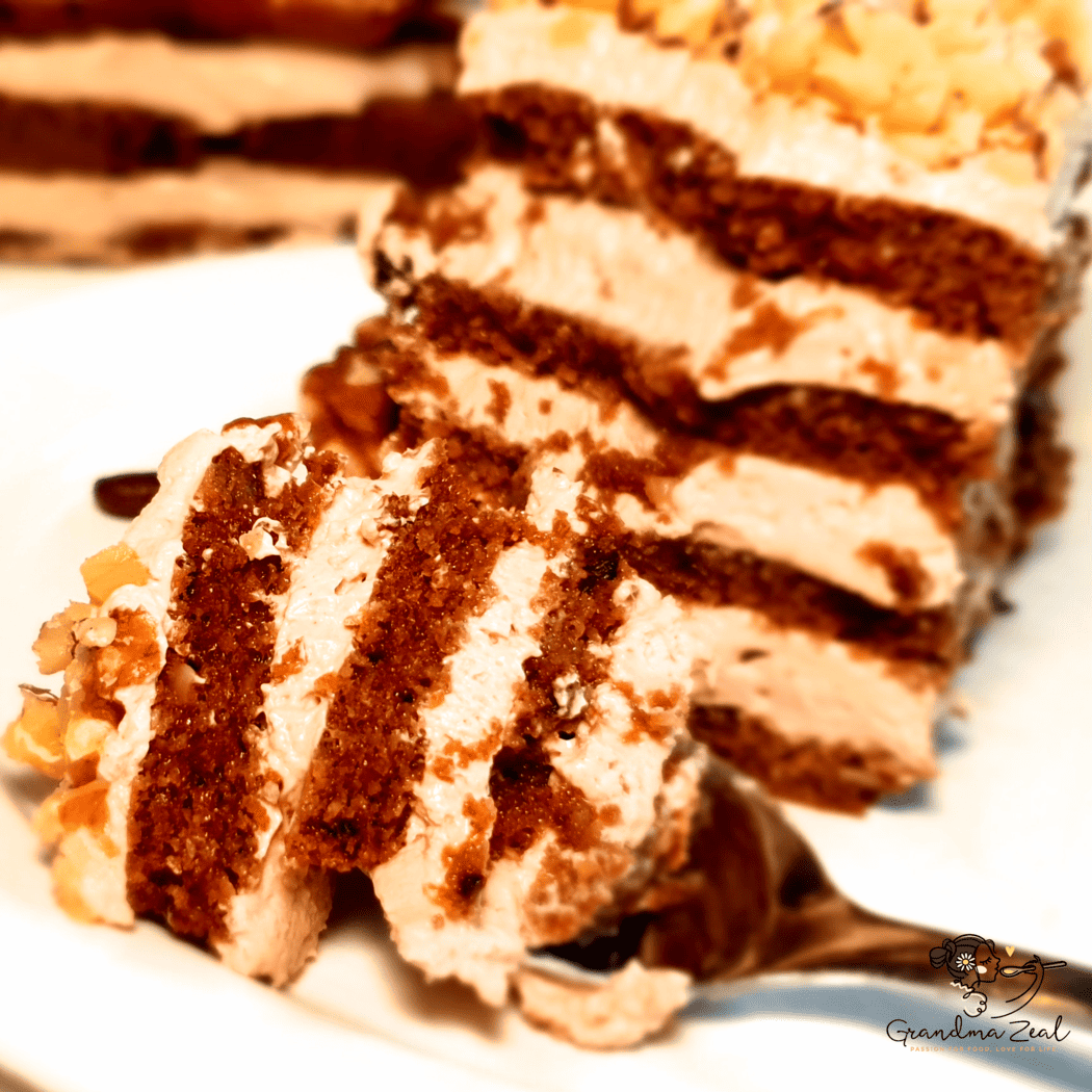 A portion of low-carb coffee walnut cake with a piece on the fork, ready to eat.