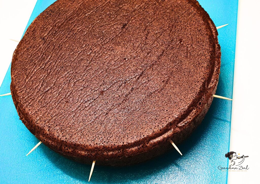 Chocolate sponge cake ready to be cut in 3 slices
