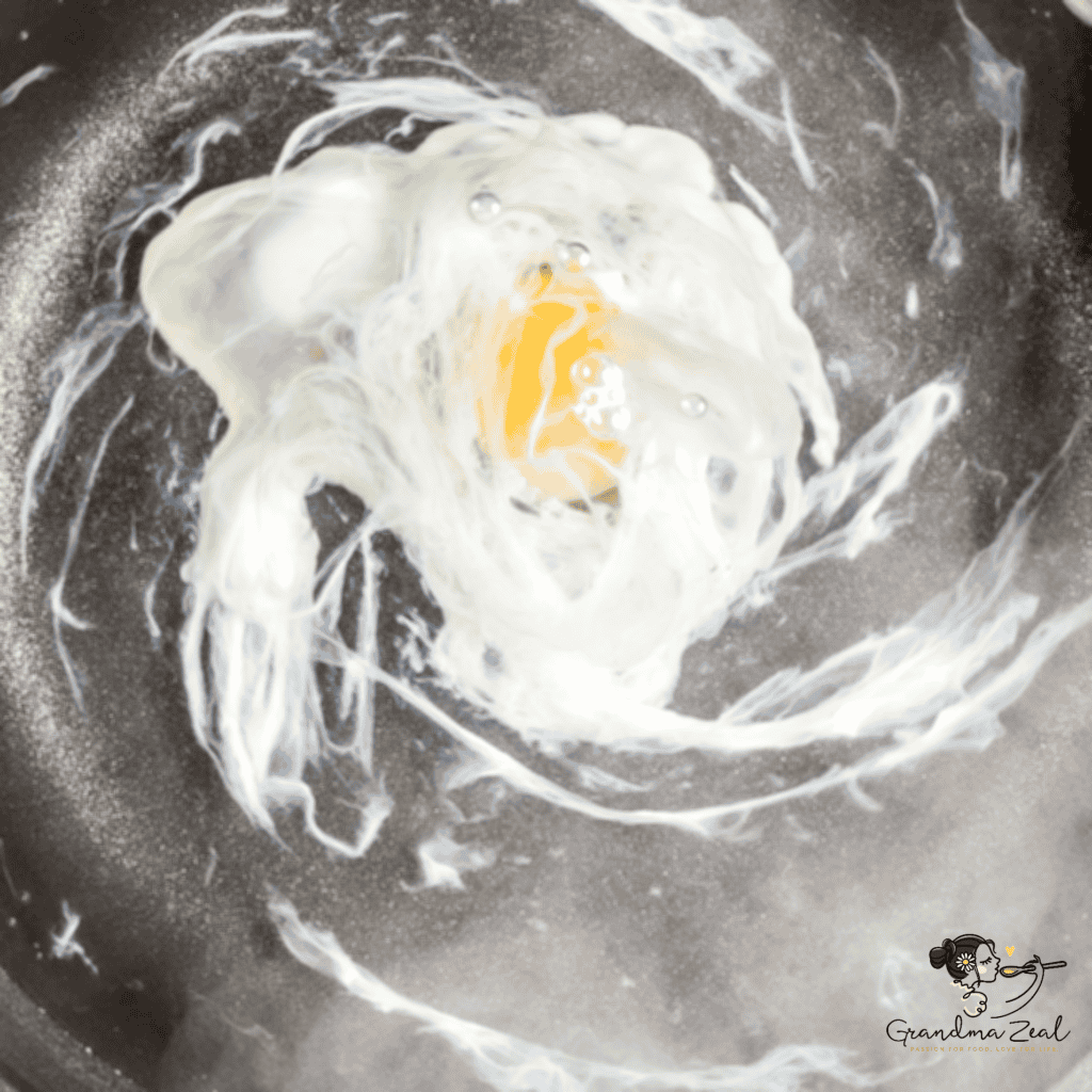 HOW TO COOK PERFECT POACHED EGG swirls of water in the pot with egg