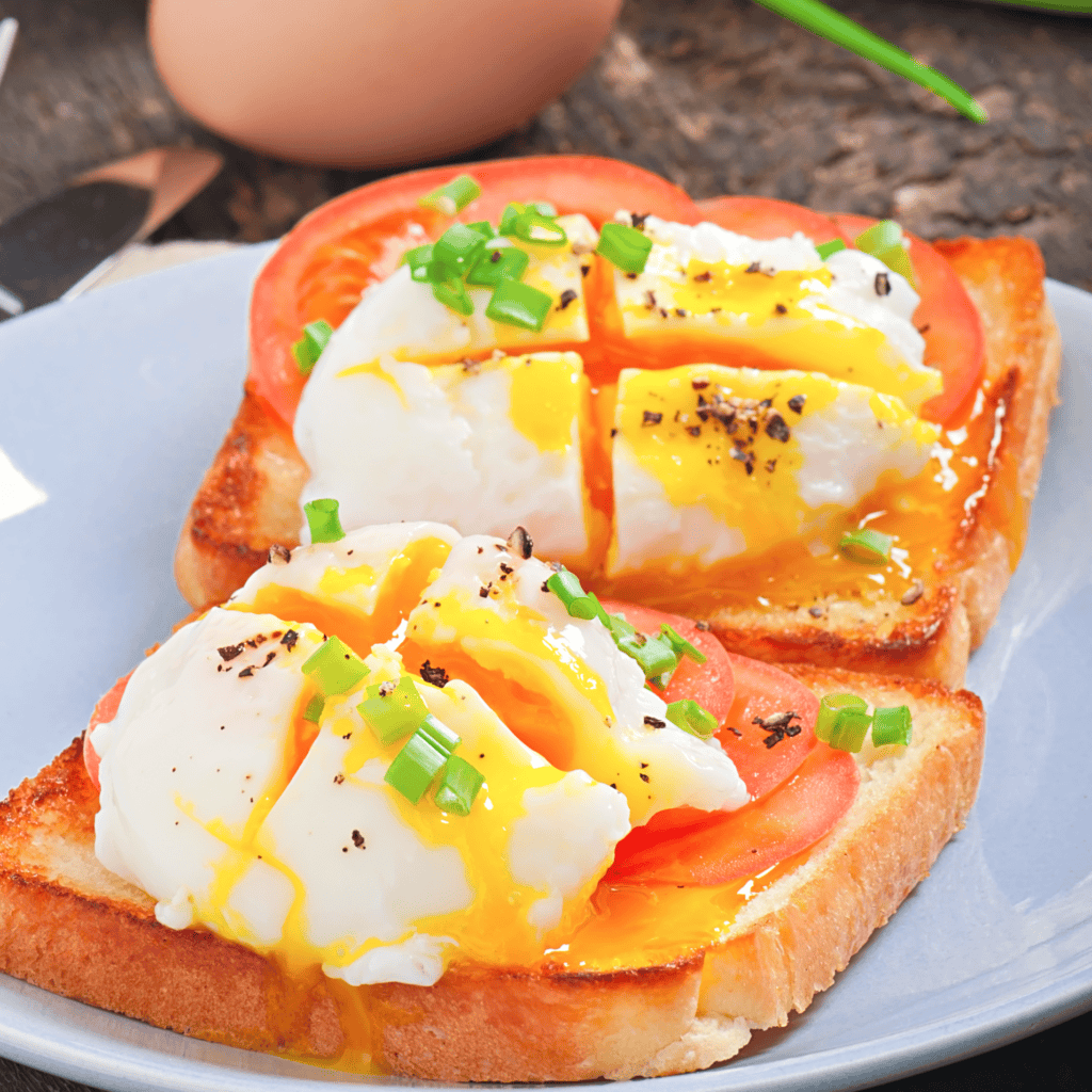 HOW TO COOK PERFECT POACHED EGG 2 slices of the toast with a perfect poached egg on each, served on the plate