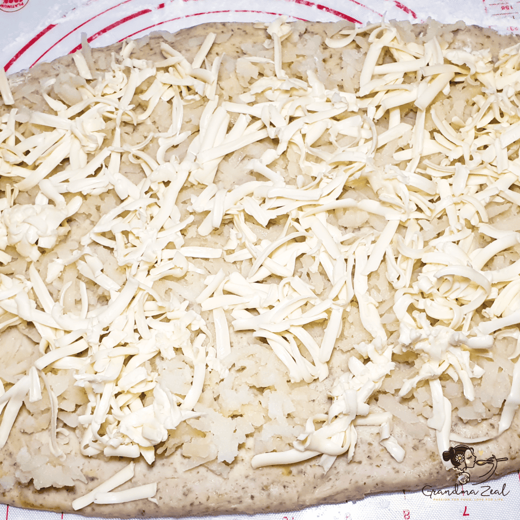 grated butter and potato over the dough for potato scones