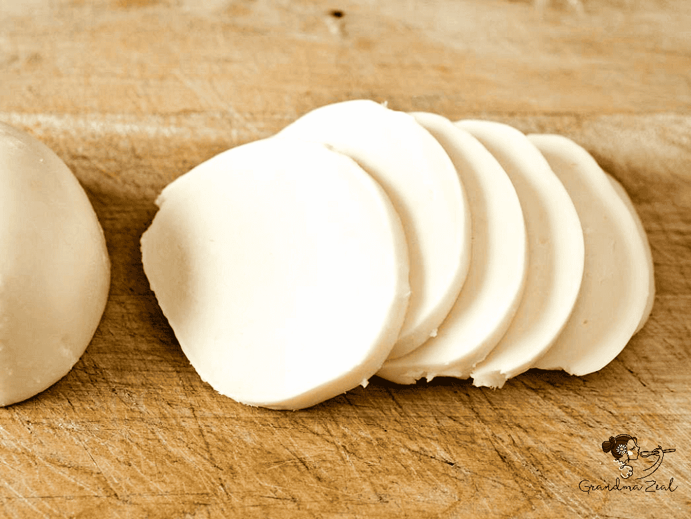 sliced mozzarella on the chopping board, prepared for stuffed pumpkin