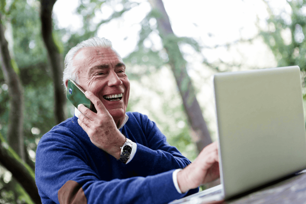 How to Embrace Ageing with Confidence man with laptop talking into mobile
