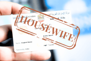 A blurry picture of an ID card with a big stamp over it saying HOUSEWIFE