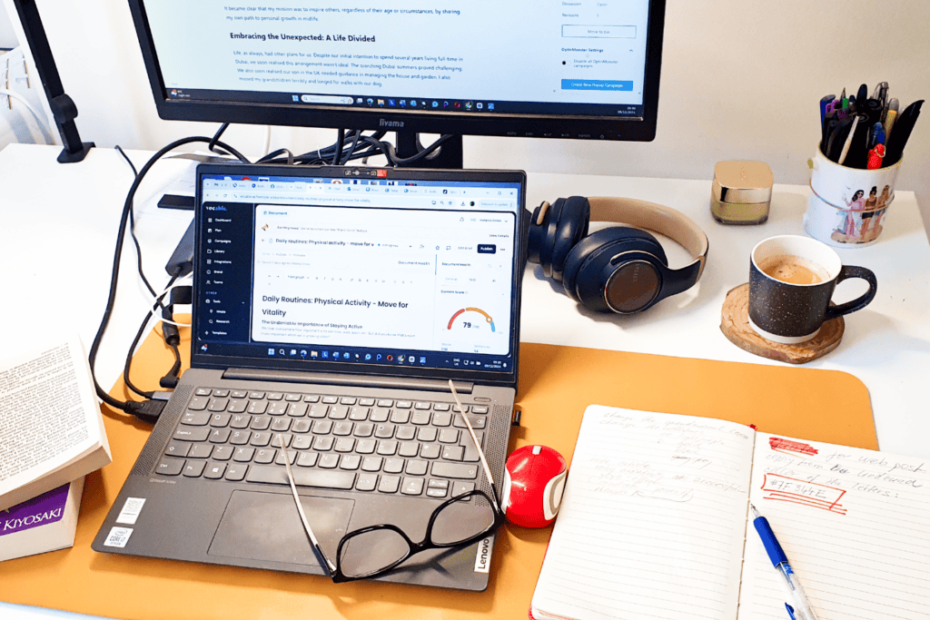 Laptop, notebook, books, and coffee on a desk — a calm workspace for personal growth and midlife reflection