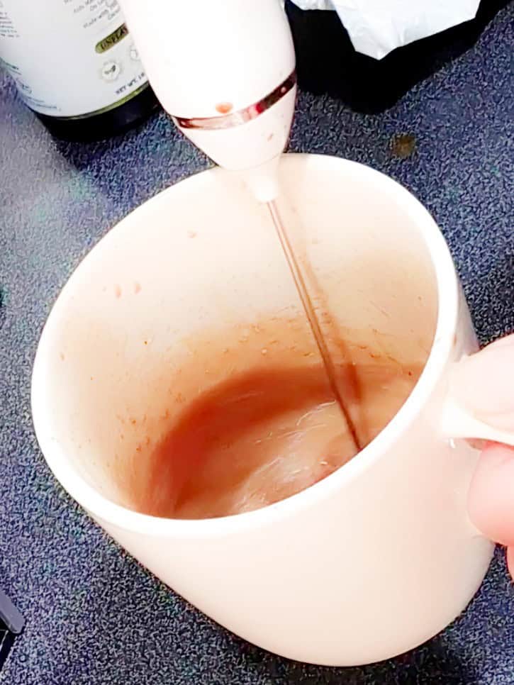 the picture is showing how to make bulletproof coffee smooth with a whisk
