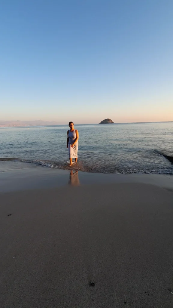 Helena walking out of the sea onto the beach reflecting on the journey behind GrandmaZeal