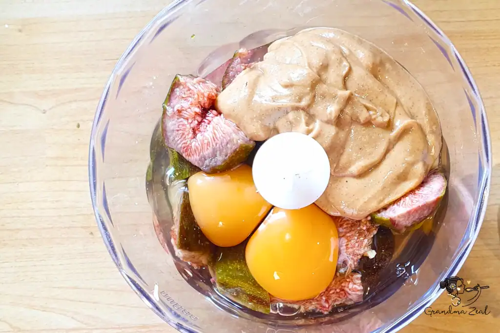 Wet ingredients blended in a food processor with figs, eggs, and nut butter to make baked protein bars