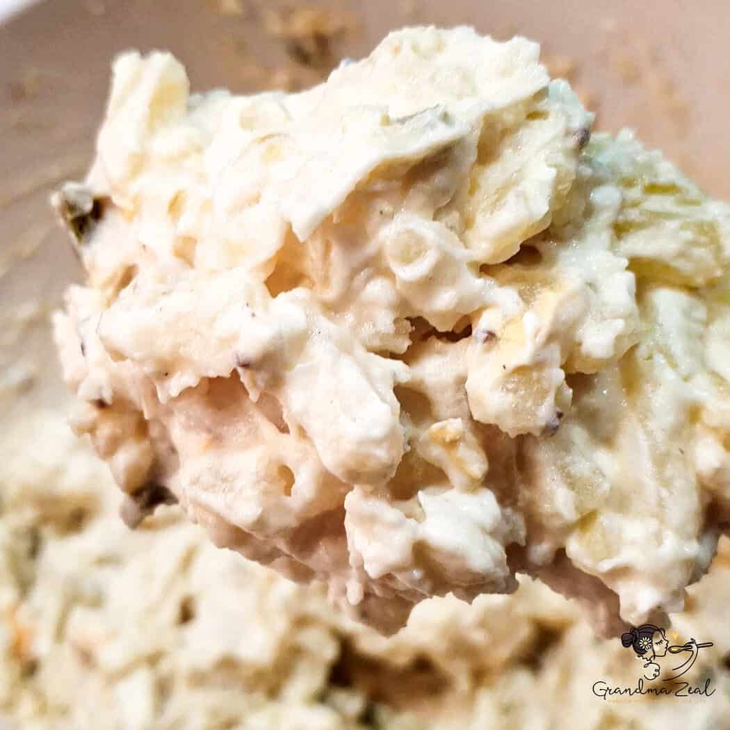 A spoonful of creamy homemade potato salad showing texture and dressing