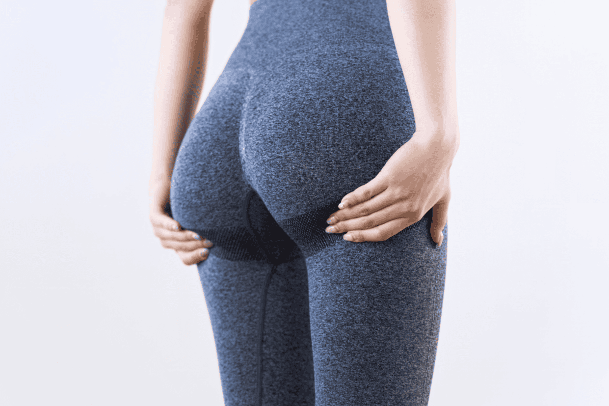 Close-up of a woman’s lower body in activewear, highlighting legs and glutes for strength exercises.